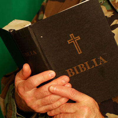 A soldier holding a bible