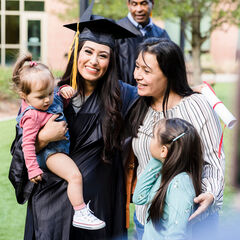 A graduate her family group hugging