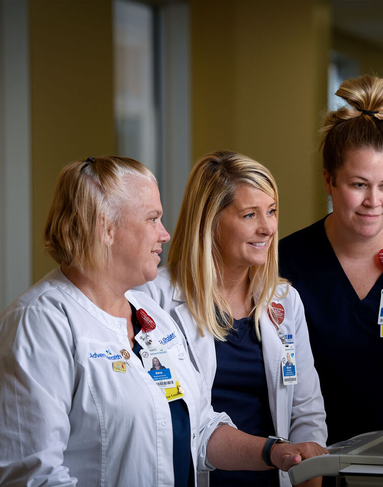 A nursing director and two employees viewing a monitor