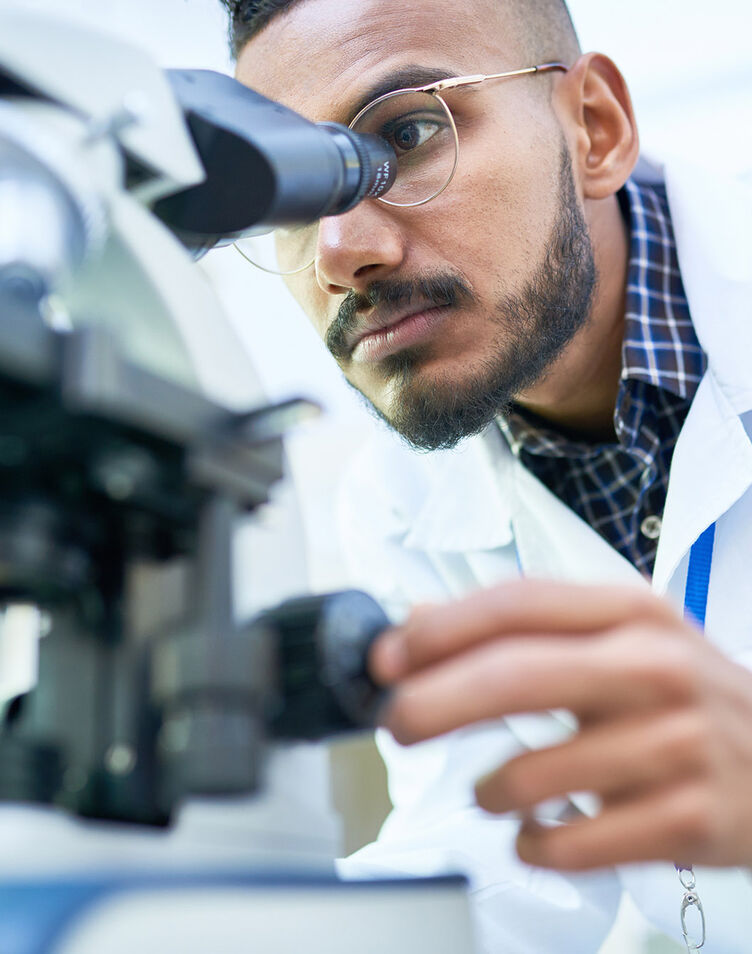 Physician using microscope