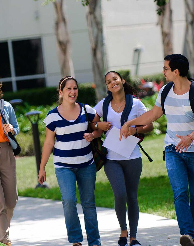 A group of students walking outside on AHU's campus