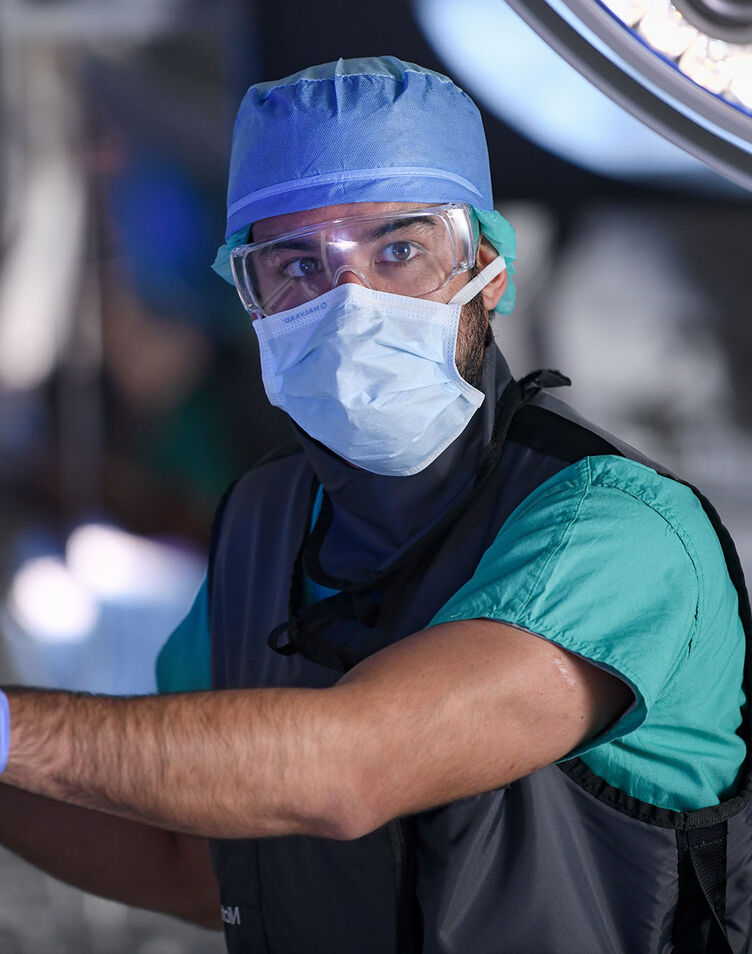 A healthcare worker operating an imaging machine during surgery